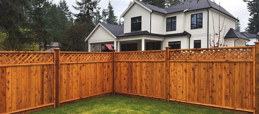 Solid privacy cedar fence installed along a backyard property line